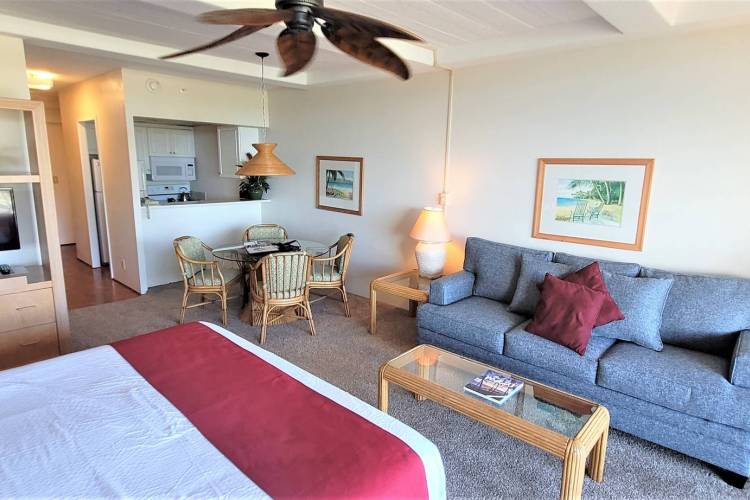 Studio condo at the Whaler Resort in Kaanapali featuring one queen bed, one bathroom, a couch, dining table, full kitchen, and a private balcony in Hawaii.