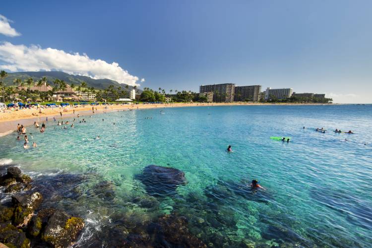 People swimming in the ocean at Kaanapali Beach from Black Rock, Maui, Hawaii.