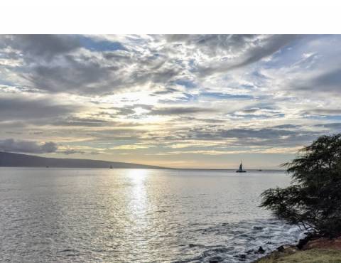 Sunset View from Wahikuli Wayside Park Sunset view with a sailboat by the island of Lanai, view from Maui Wahikuli Wayside park