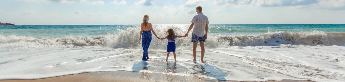 Maui family vacation, family looking at the ocean, standing on the beach